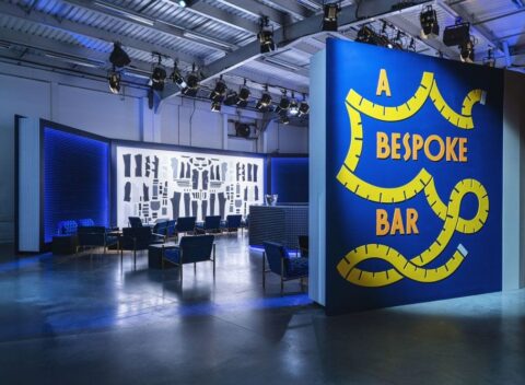 Bespoke bar installation with bold blue branding and lounge seating