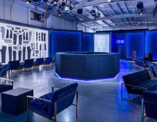 Modern event space with blue lighting and curved reception desk