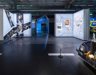 Modern exhibition space with interactive displays and vehicles