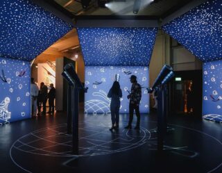 Planetarium exhibition with telescopes and starry ceiling display