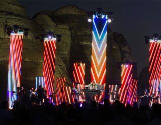 Concert stage with neon vertical light displays at night