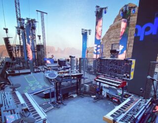 Outdoor music festival stage setup with desert landscape