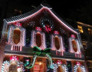 Elaborately decorated gingerbread house with festive lights