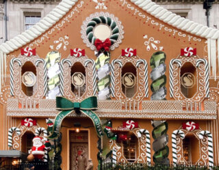 Elaborate gingerbread house holiday storefront decoration