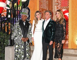 Four people in formal evening wear at festive venue
