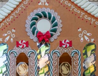 Giant gingerbread house facade with holiday decorations