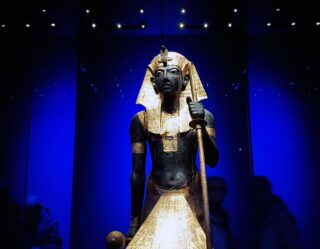 Ancient Egyptian pharaoh statue with golden headdress