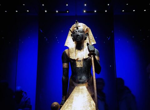 Ancient Egyptian pharaoh statue with gold headdress