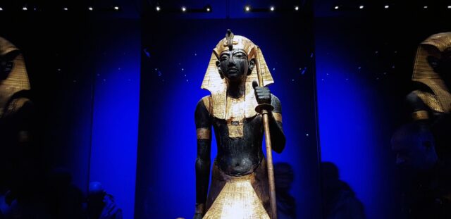 Ancient Egyptian pharaoh statue with gold headdress