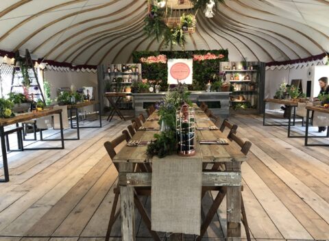 Elegant garden tent event venue with long dining table