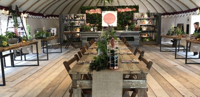 Elegant garden tent event venue with long dining table