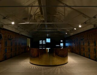 Modern museum gallery with wooden wall panels and central display