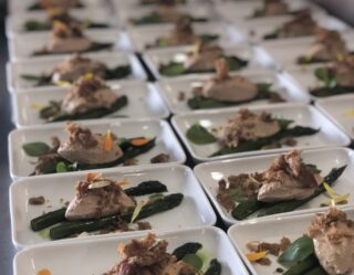 Plated gourmet appetizers with asparagus and garnish