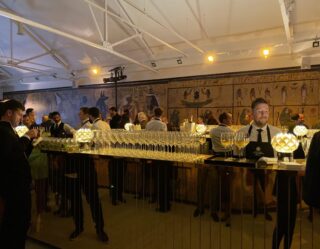 Upscale bar event with Egyptian-themed backdrop