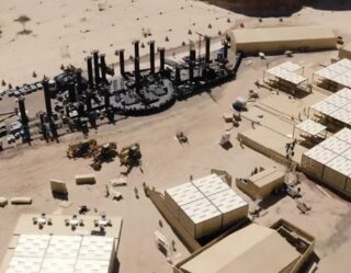 Military base with tents and equipment in desert