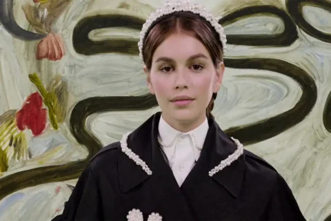 Young girl in black dress with pearl trim and headband