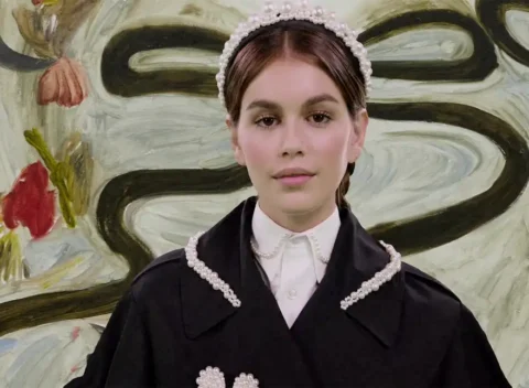 Young girl in black dress with pearl trim and headband