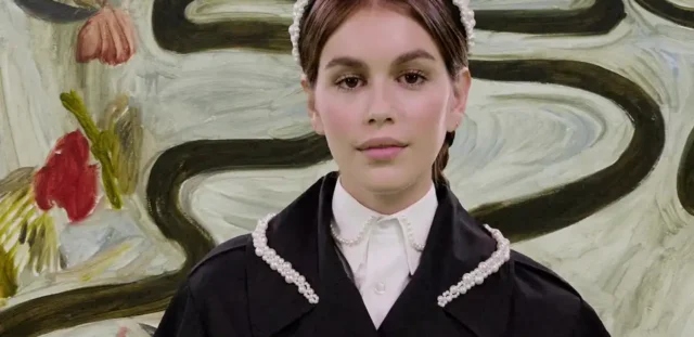 Young girl in black dress with pearl trim and headband