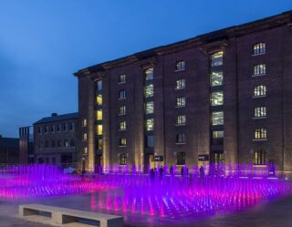 Evening courtyard with purple illuminated fountain display
