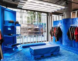 Modern retail clothing store with blue fixtures and displays