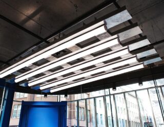 Modern linear LED ceiling lights in industrial space