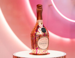 Laurent-Perrier champagne bottle on white pedestal