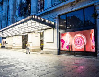 Modern retail storefront with illuminated display at dusk