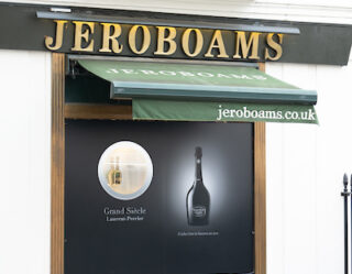 Jeroboams wine shop storefront with green awning