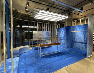 Modern blue retail display space with glass partitions