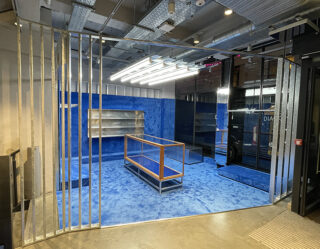Empty retail store under construction with blue flooring