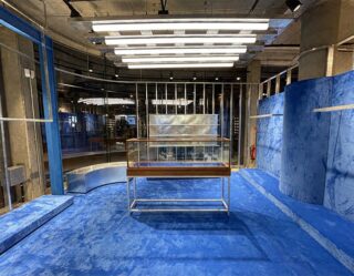 Empty retail storefront under construction with blue coverings