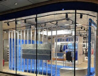 Modern retail clothing store with blue accents