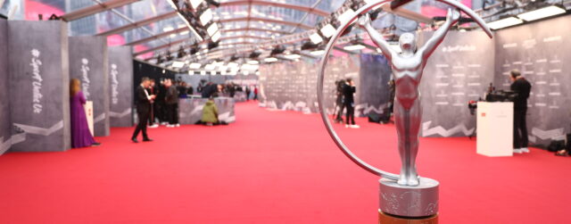 Silver award statue on red carpet at awards ceremony